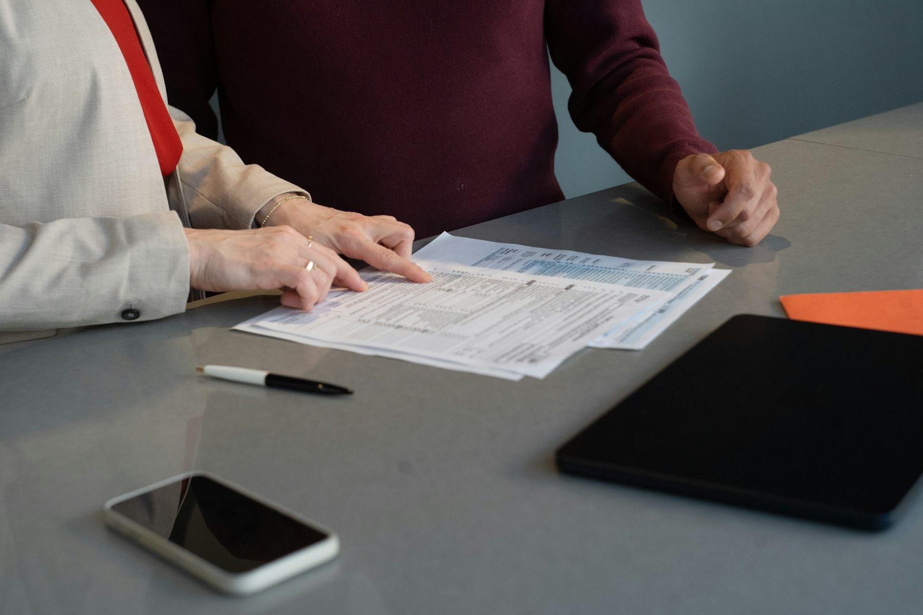 Two people reviewing documents together at a desk